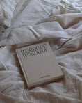 Load image into Gallery viewer, Book titled 'Words of Introspection - lined journal' on a bed